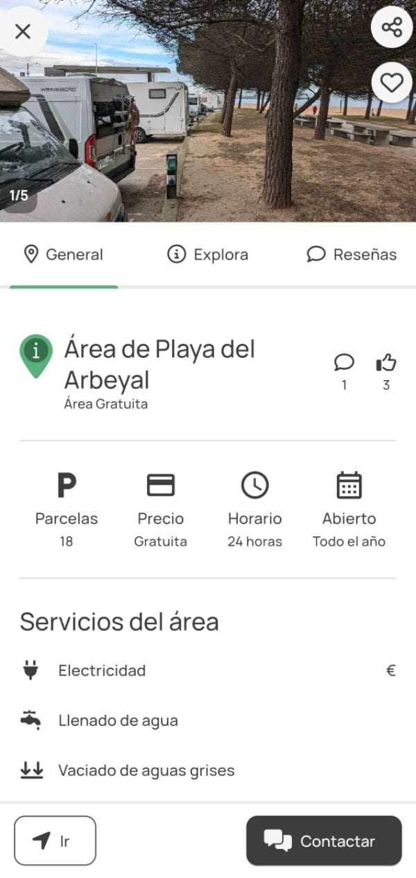 utocaravanas aparcadas junto a una zona arbolada en la Playa del Arbeyal, con mesas de picnic y el mar visible al fondo.