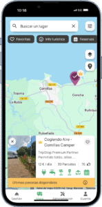Mapa interactivo de una aplicación móvil mostrando el área para autocaravanas "Cogiendo Aire - Comillas Camper", ubicada cerca de Comillas, Cantabria, con detalles como precio, servicios y disponibilidad.